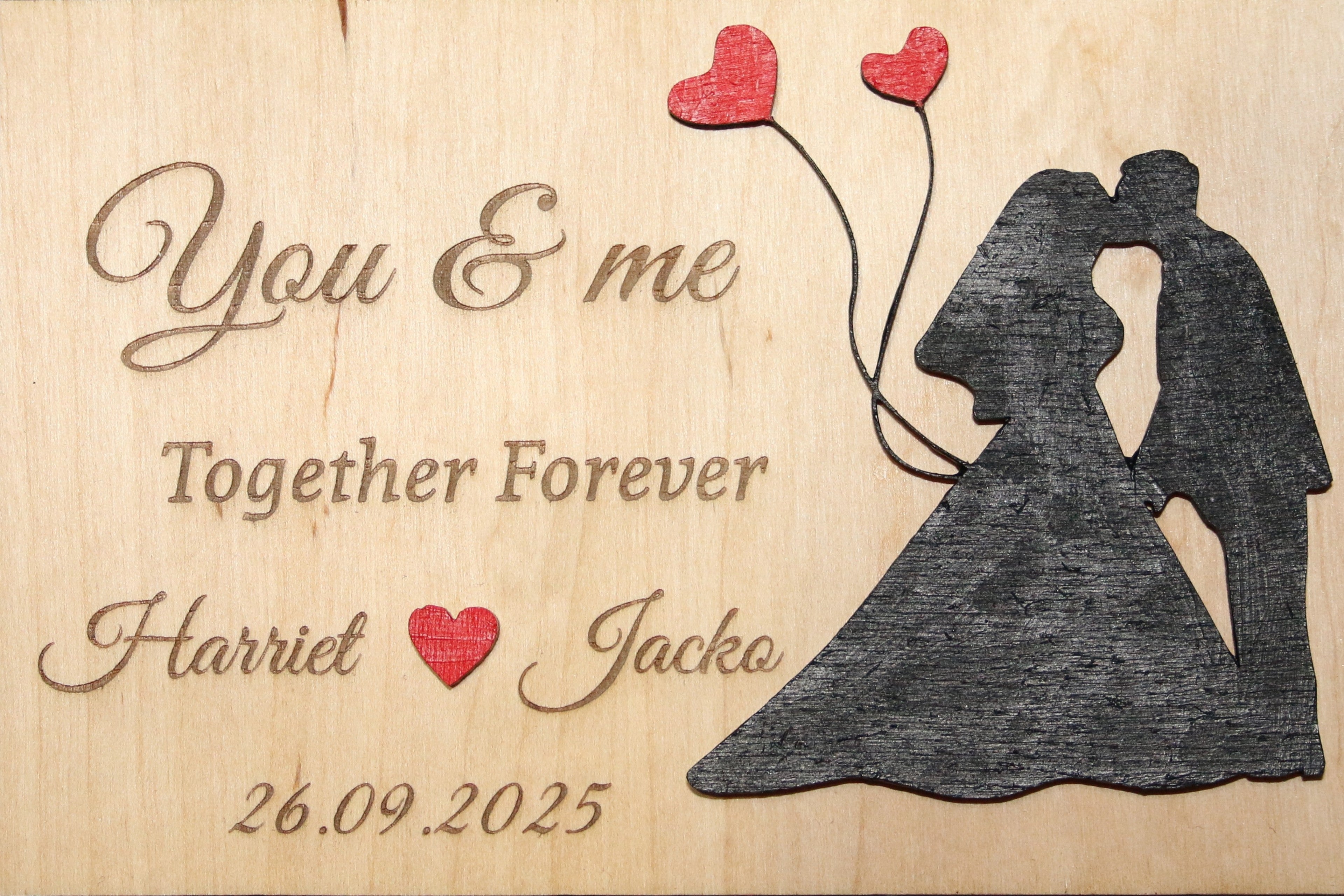 Personalized wooden plaque with engraved wedding couple, hearts, names, and date
