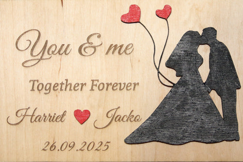 Personalized wooden plaque with engraved wedding couple, hearts, names, and date
