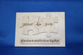 Personalized wooden puzzle plaque with engraved names, heart, and message assembled on blue background