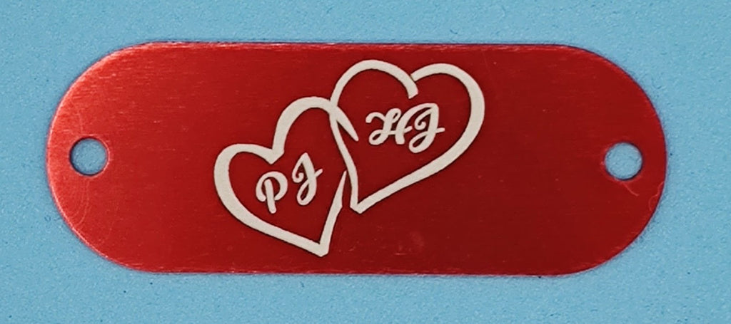 Red aluminum nameplate with engraved double heart and initials PJ HJ