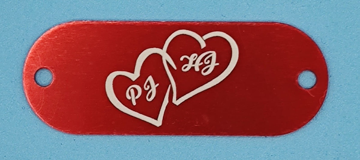 Red aluminum nameplate with engraved double heart and initials PJ HJ